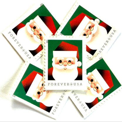 Head of Santa Claus postage stamps from 2021 featuring a close-up of a smiling, winking St. Nick against a green background on unused USPS Forever postage, Scott 5646.