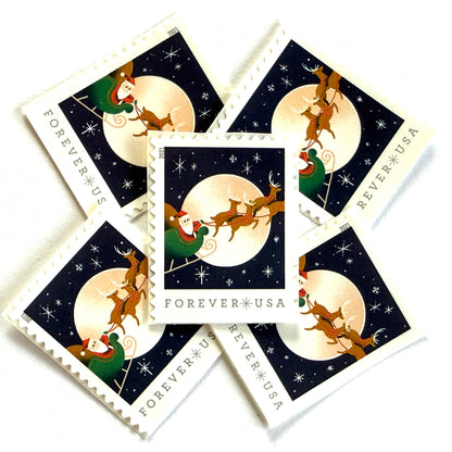 Santa Claus, Sleigh, and Reindeer in Flight postage stamps from 2021 featuring St. Nick and four reindeer flying across a full moon in a dark star-filled sky on unused USPS Forever postage, Scott 5647.