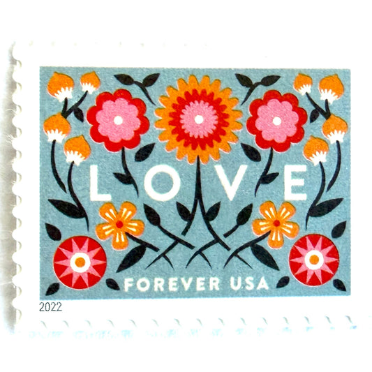 Love 2022 blue floral postage stamp featuring folk-art flowers, twisting vines, and abstract hearts on unused USPS Forever postage, Scott 5660.