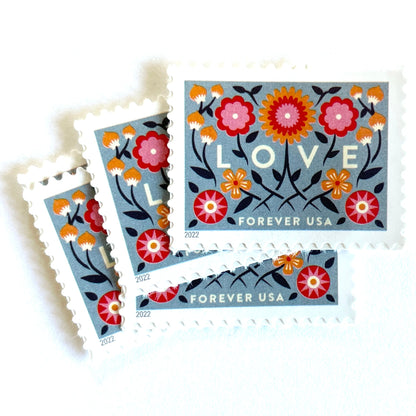 Love 2022 blue floral postage stamps featuring folk-art flowers, twisting vines, and abstract hearts on unused USPS Forever postage, Scott 5660.