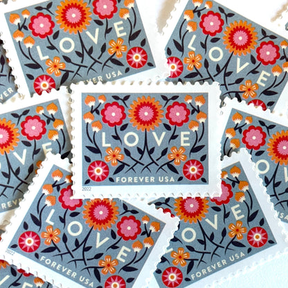 Love 2022 blue floral postage stamps featuring folk-art flowers, twisting vines, and abstract hearts on unused USPS Forever postage, Scott 5660.