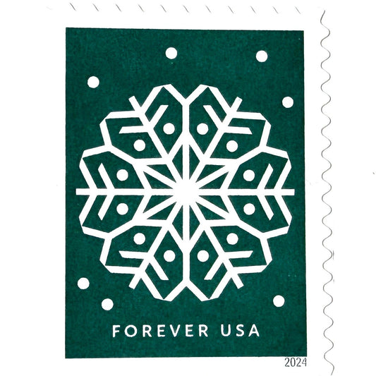 Dark green Winter Whimsy Snowflake postage stamp from 2024 featuring a white symmetrical paper-cut-inspired winter design on unused USPS Forever postage, Scott 5951.
