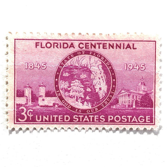 Image of Florida Statehood Centennial postage stamps from 1945, featuring the Florida state seal, the Gates of St. Augustine, and the State Capitol at Tallahassee on vintage pink/red unused 3-cent USPS postage, Scott 927.