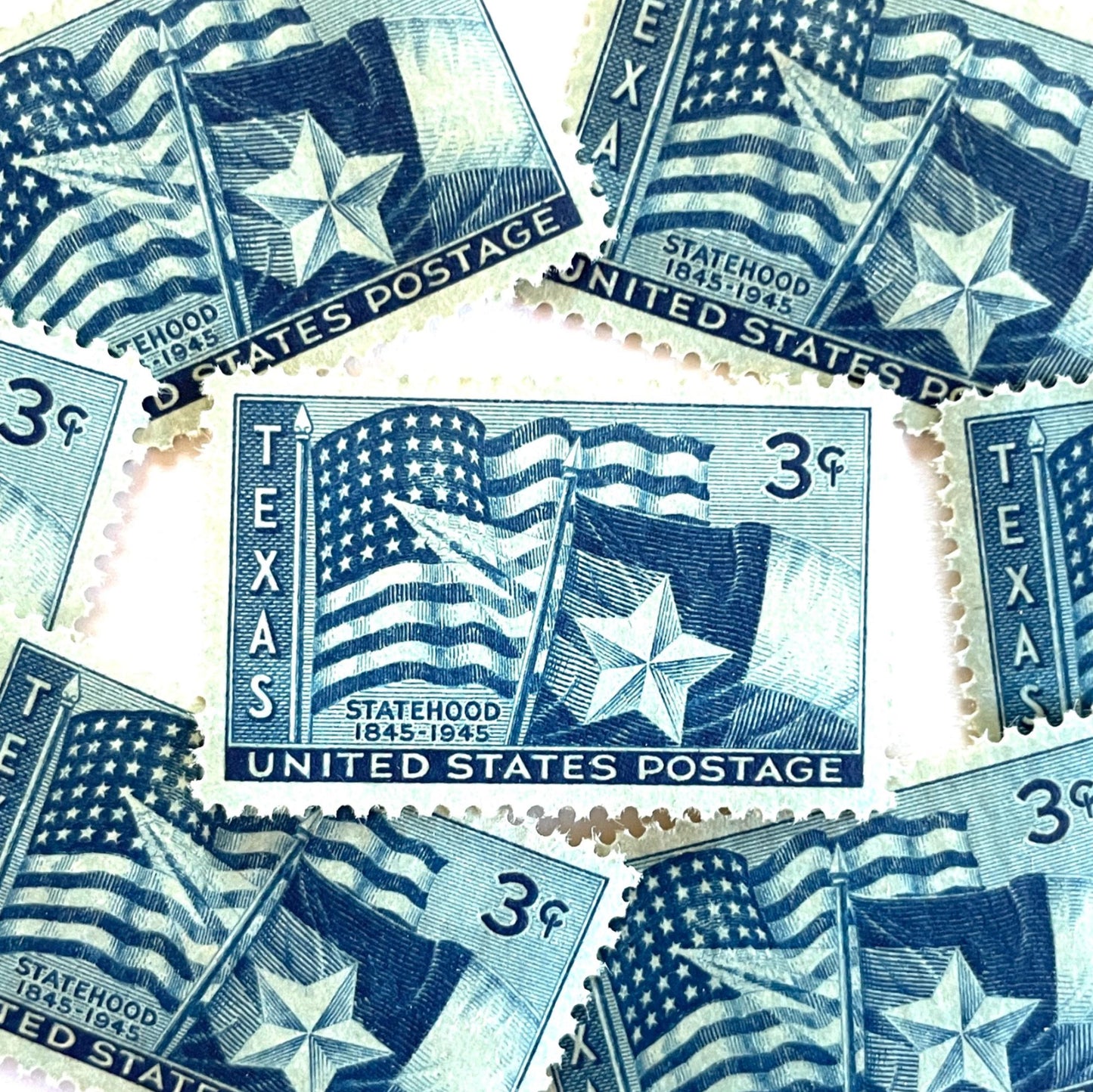Image of 1945 Texas Statehood 3-cent dark blue postage stamps. Scott #938. Stamp themes: Texas, Lone Star State, Texas flag, U.S. flag, patriotic, statehood centennial, American history.