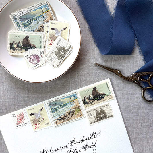 Unused vintage beach stamp set for mailing beach, nautical, coastal, and marine-themed save-the-dates, wedding invitations, bridal shower invitations, and other special correspondence. Each curated set is comprised of eight unused stamps with a total USPS postage value of 87 cents — enough postage to mail a standard rectangular envelope that weighs up to one ounce.