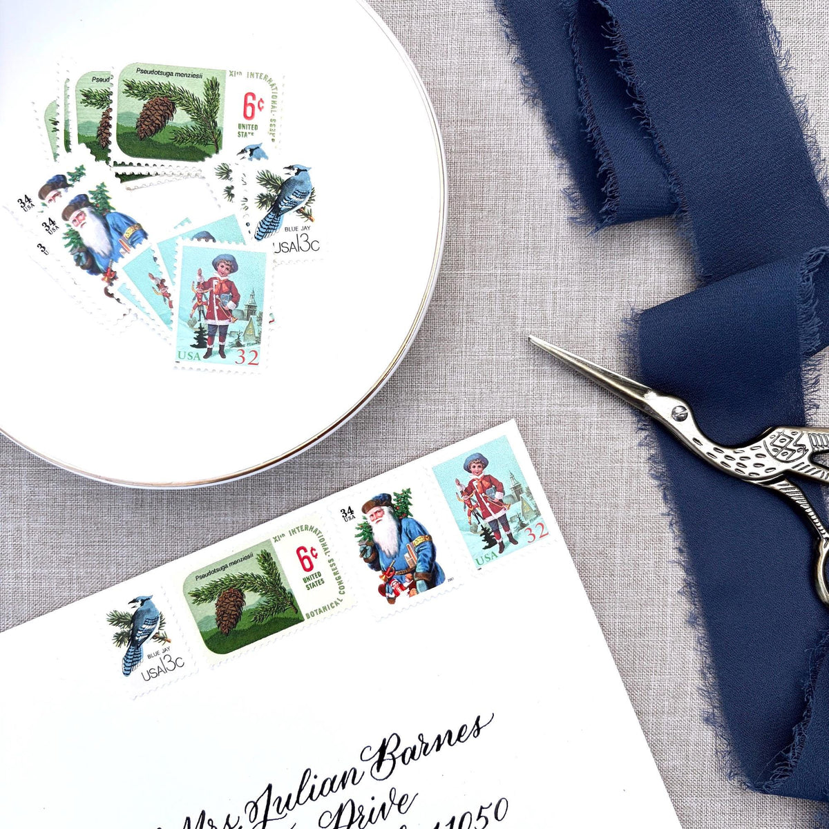 Unused Blue Christmas vintage postage stamp set perfect for adding a special touch to your holiday cards or letters! Each curated set is comprised of four (4) unused stamps with a total USPS postage value of $0.85 (USD) per set — enough postage to mail a standard letter weighing up to 1-ounce.