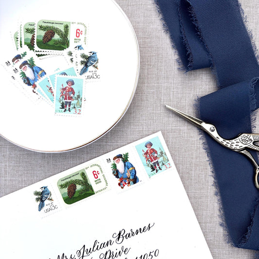 Unused Blue Christmas vintage postage stamp set perfect for adding a special touch to your holiday cards or letters! Each curated set is comprised of four (4) unused stamps with a total USPS postage value of $0.85 (USD) per set — enough postage to mail a standard letter weighing up to 1-ounce.