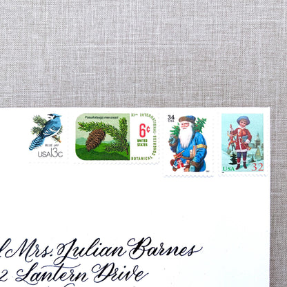 Unused Blue Christmas vintage postage stamp set perfect for adding a special touch to your holiday cards or letters! Each curated set is comprised of four (4) unused stamps with a total USPS postage value of $0.85 (USD) per set — enough postage to mail a standard letter weighing up to 1-ounce.