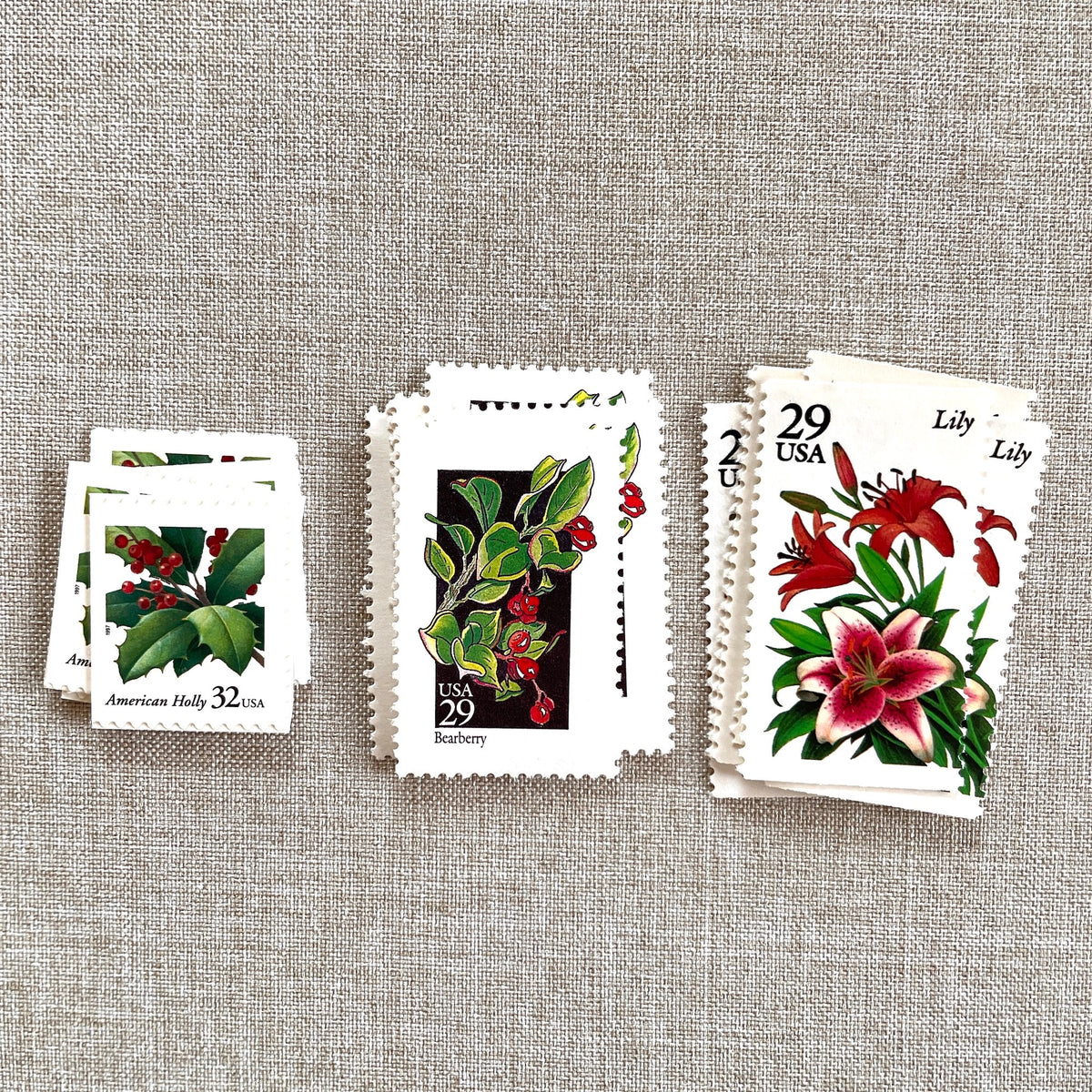 Unused “Botanical Christmas” vintage postage stamp set perfect for adding a special touch to your holiday cards or letters! Each curated set is comprised of three (3) unused stamps with a total USPS postage value of $0.90 (USD) per set — enough postage to mail a standard letter weighing up to 1-ounce.