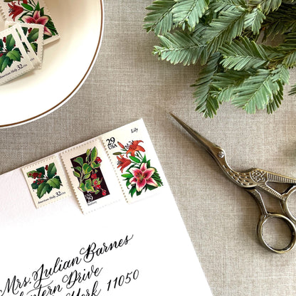 Unused “Botanical Christmas” vintage postage stamp set perfect for adding a special touch to your holiday cards or letters! Each curated set is comprised of three (3) unused stamps with a total USPS postage value of $0.90 (USD) per set — enough postage to mail a standard letter weighing up to 1-ounce.