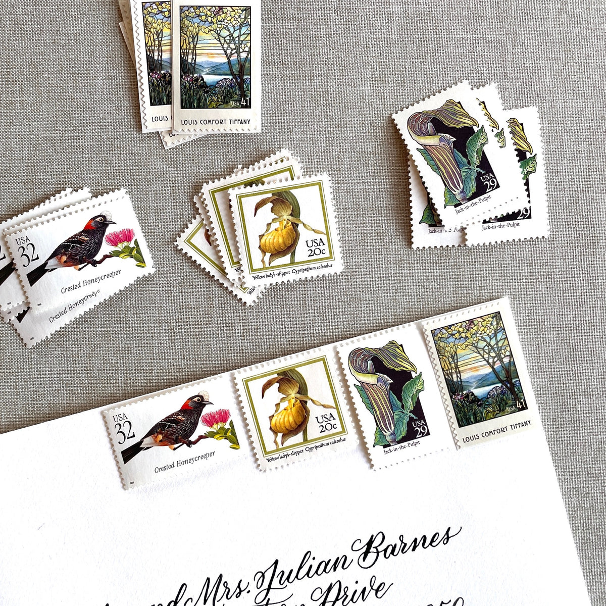 Vintage botanical postage stamp set featuring Crested Honeycreeper, Lady’s-Slipper Orchid, Jack-in-the-Pulpit Wildflower, and Louis Comfort Tiffany unused U.S. stamps for wedding invitations and save-the-dates.
