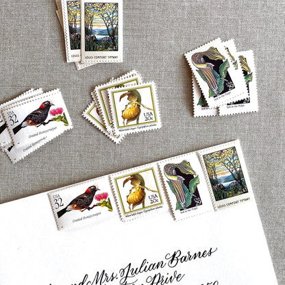 Vintage botanical postage stamp set featuring Crested Honeycreeper, Lady’s-Slipper Orchid, Jack-in-the-Pulpit Wildflower, and Louis Comfort Tiffany unused U.S. stamps for wedding invitations and save-the-dates.