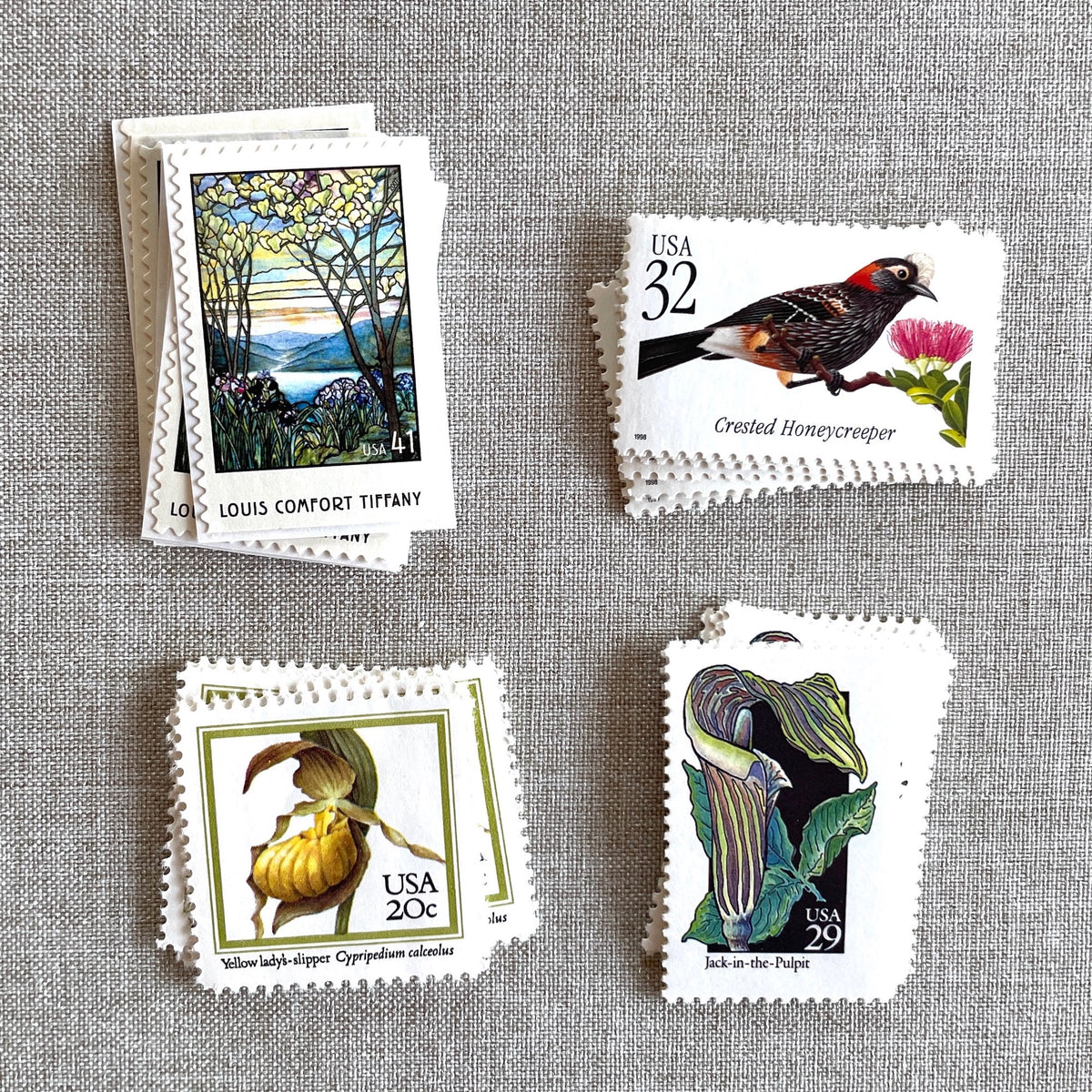 Vintage botanical postage stamp set featuring Crested Honeycreeper, Lady’s-Slipper Orchid, Jack-in-the-Pulpit Wildflower, and Louis Comfort Tiffany unused U.S. stamps for wedding invitations and save-the-dates.