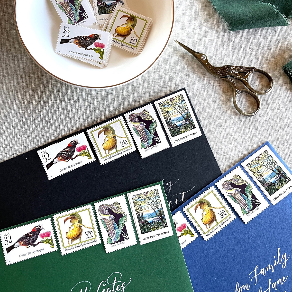 Vintage botanical postage stamp set featuring Crested Honeycreeper, Lady’s-Slipper Orchid, Jack-in-the-Pulpit Wildflower, and Louis Comfort Tiffany unused U.S. stamps for wedding invitations and save-the-dates.