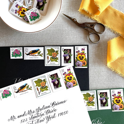 Vintage botanical postage stamp set featuring African Violet, Antillean Euphonia, Yellow Poplar, Rosebud Orchid, and Pansy unused U.S. postage stamps for wedding invitations and save-the-dates.