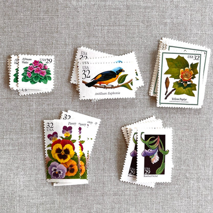 Vintage botanical postage stamp set featuring African Violet, Antillean Euphonia, Yellow Poplar, Rosebud Orchid, and Pansy unused U.S. postage stamps for wedding invitations and save-the-dates.