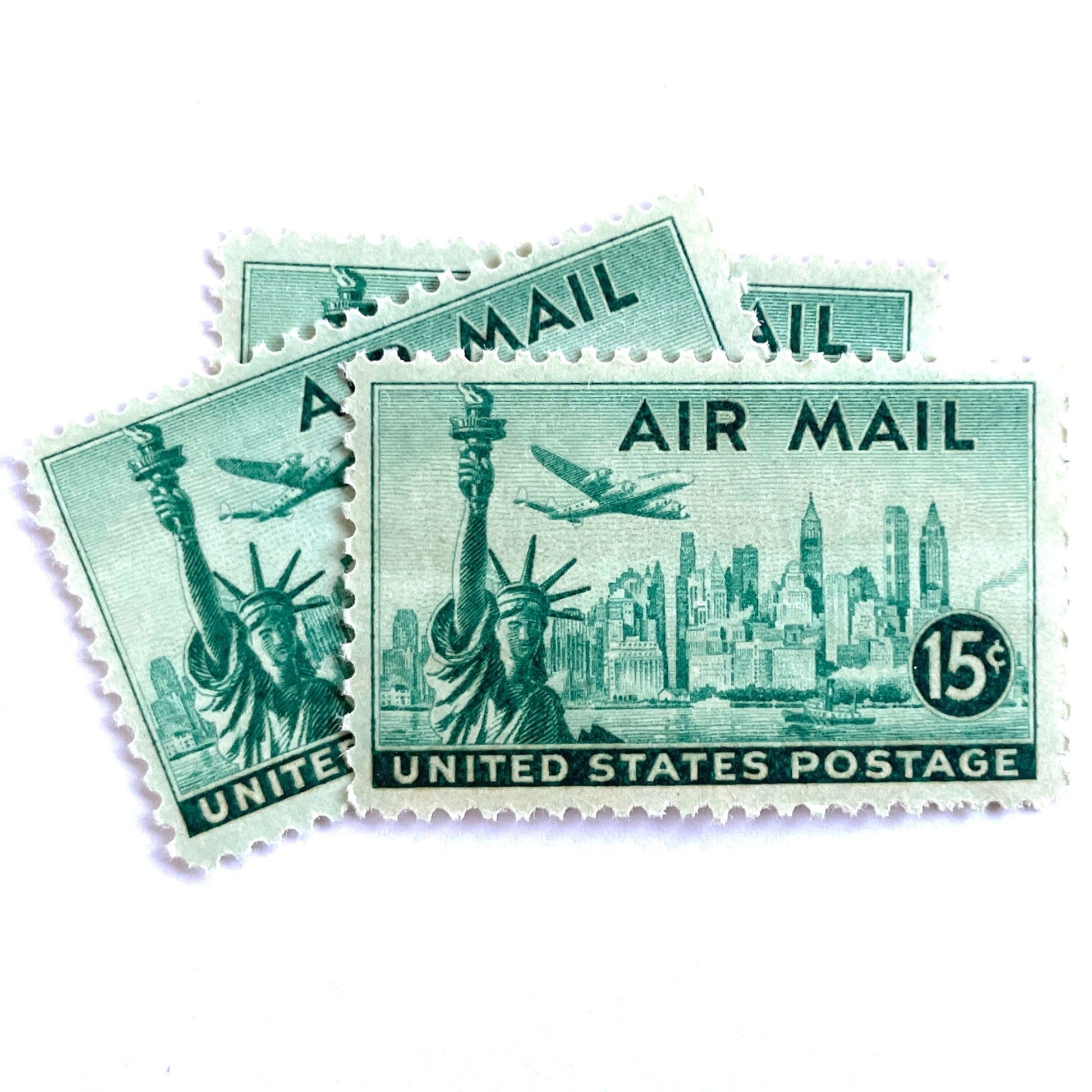 Image of 1947 “New York Skyline” 15-cent Air Mail stamps. Scott #C35. Stamp Themes: New York, NYC, Big Apple, Statue of Liberty, Chrysler Building, Air Mail, Air Travel, Transportation. Green postage stamp.