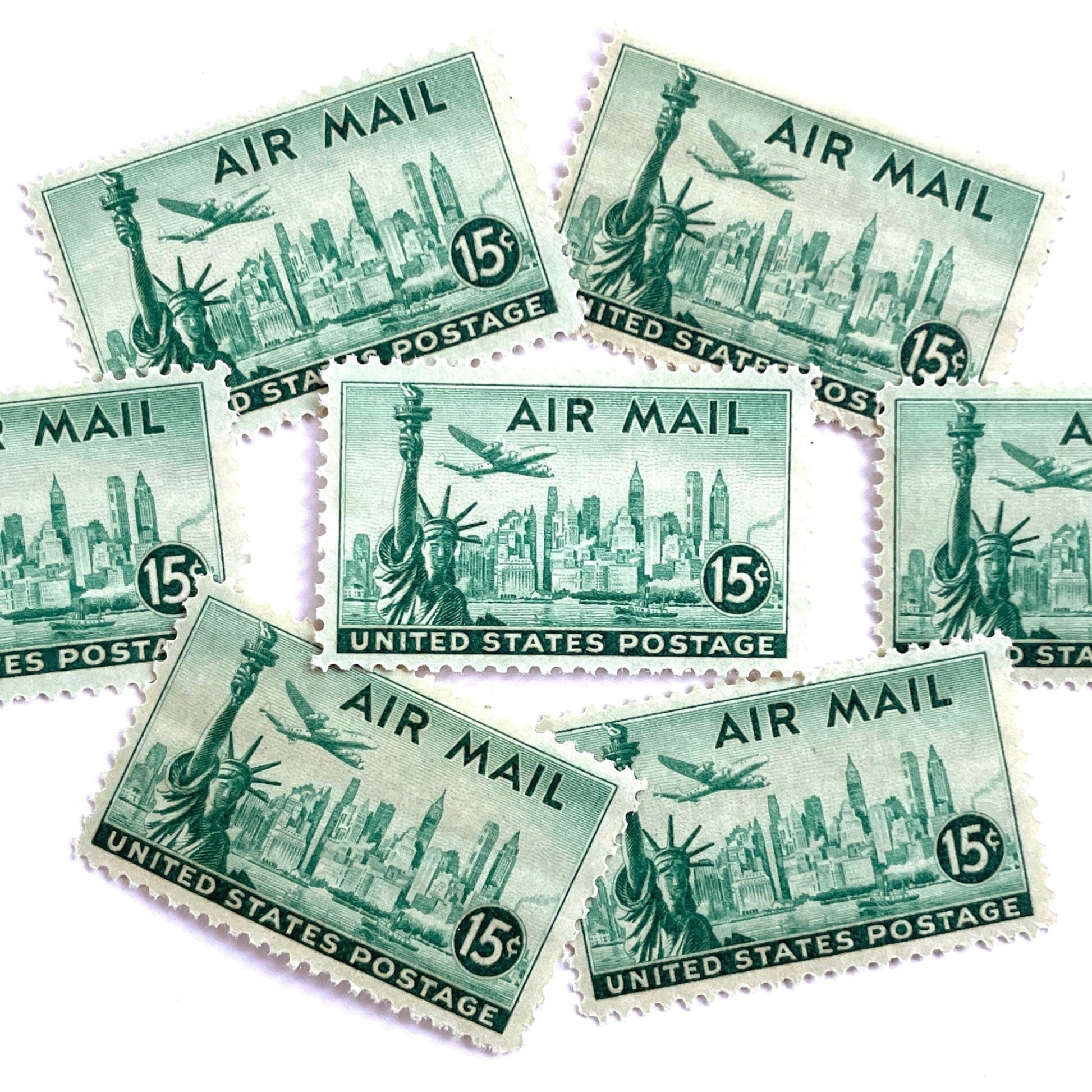 Image of 1947 “New York Skyline” 15-cent Air Mail stamps. Scott #C35. Stamp Themes: New York, NYC, Big Apple, Statue of Liberty, Chrysler Building, Air Mail, Air Travel, Transportation. Green postage stamp.