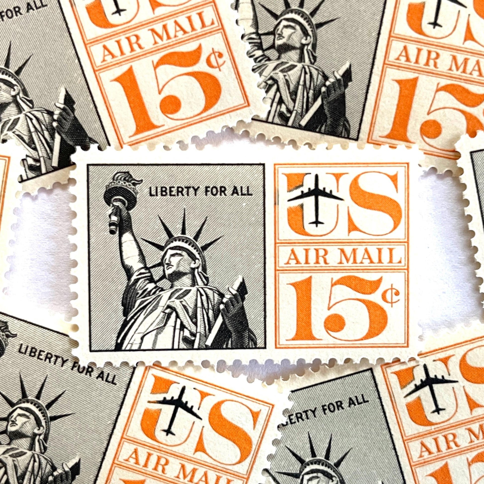 Image of 1959-1961 “Statue of Liberty” 15-cent air mail stamps. Scott #C58. Stamp Themes: Statue of Liberty, NYC, New York City, Big Apple, Air Mail. Black and orange postage stamp.