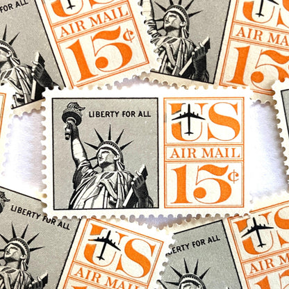 Image of 1959-1961 “Statue of Liberty” 15-cent air mail stamps. Scott #C58. Stamp Themes: Statue of Liberty, NYC, New York City, Big Apple, Air Mail. Black and orange postage stamp.