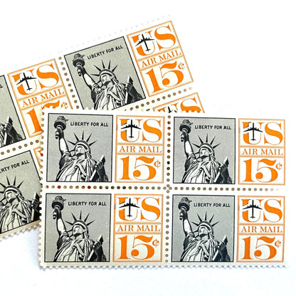 Image of 1959-1961 “Statue of Liberty” 15-cent air mail stamps. Scott #C58. Stamp Themes: Statue of Liberty, NYC, New York City, Big Apple, Air Mail. Black and orange postage stamp.