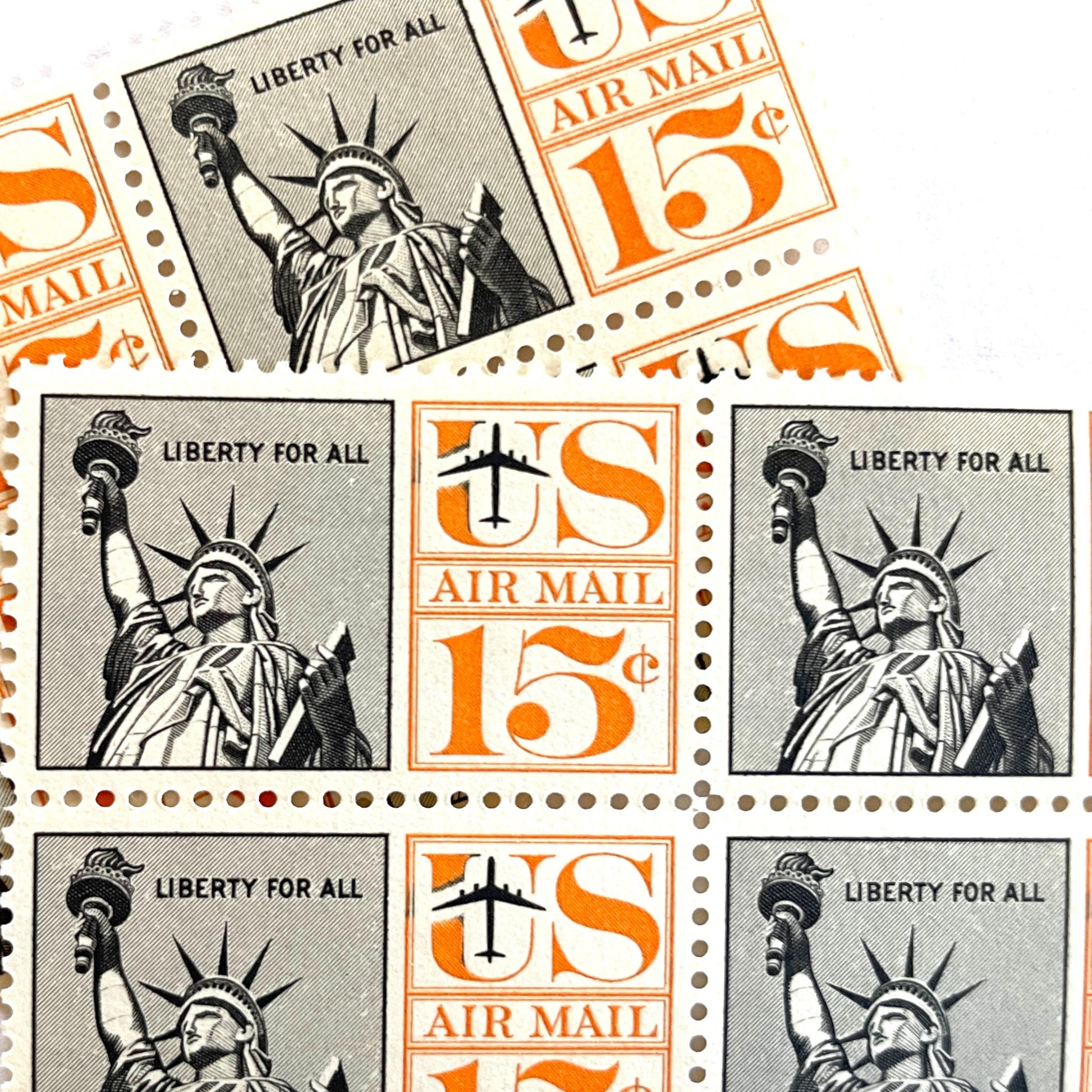 Image of 1959-1961 “Statue of Liberty” 15-cent air mail stamps. Scott #C58. Stamp Themes: Statue of Liberty, NYC, New York City, Big Apple, Air Mail. Black and orange postage stamp.