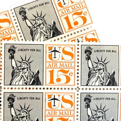 Image of 1959-1961 “Statue of Liberty” 15-cent air mail stamps. Scott #C58. Stamp Themes: Statue of Liberty, NYC, New York City, Big Apple, Air Mail. Black and orange postage stamp.