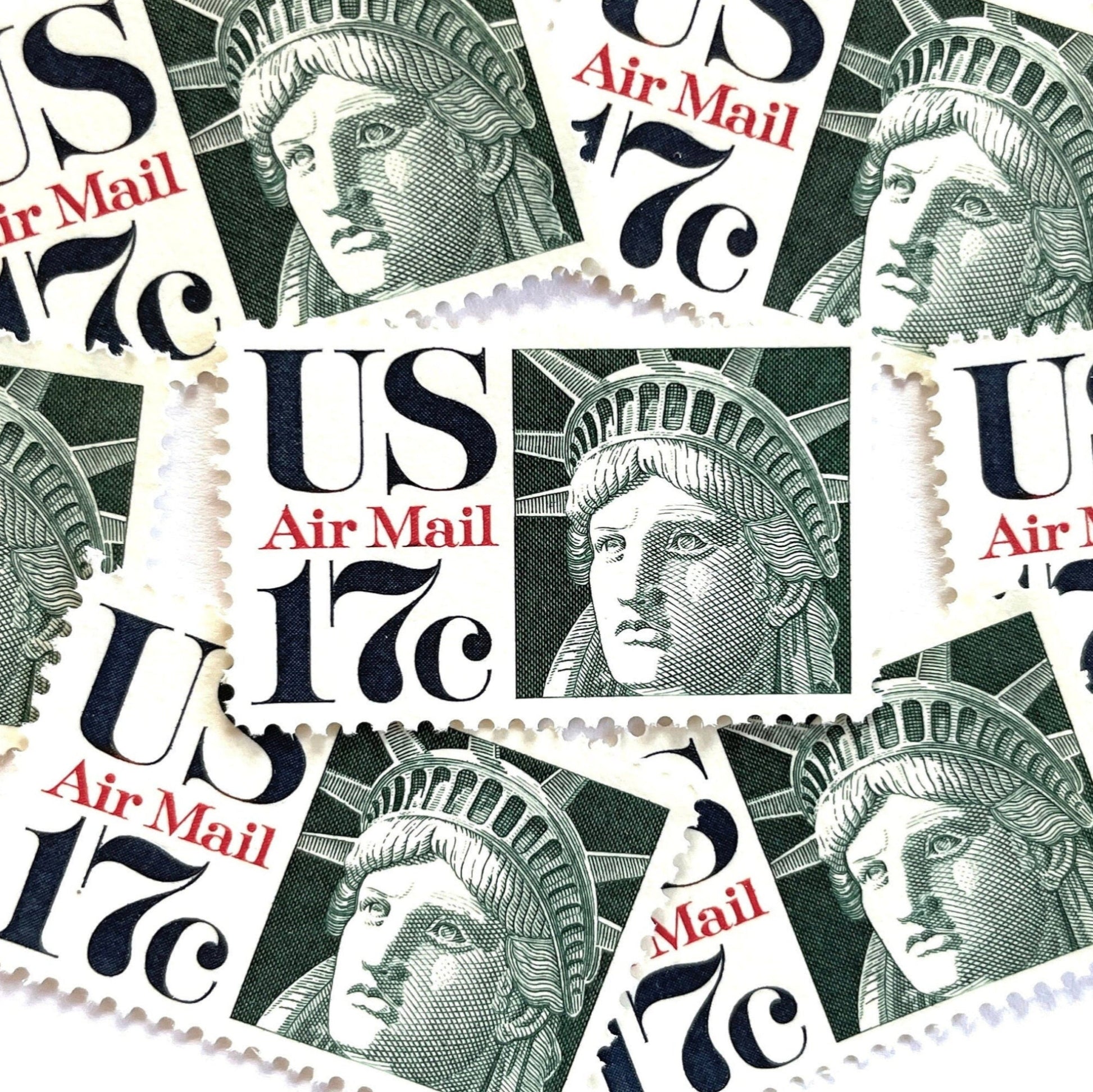 Image of 17-cent Airmail 1983 Liberty Crown USPS postage stamp featuring the Statue of Liberty. Scott #C80. Stamp themes: State of Liberty, Liberty Head, Lady Liberty, New York, NYC, Big Apple, Liberty Island, Immigrants, Immigration, Hope, Freedom, Refuge, Democracy, Crown, Torch, Tablet, Landmark, National Monument, United States of America. Green postage stamp.