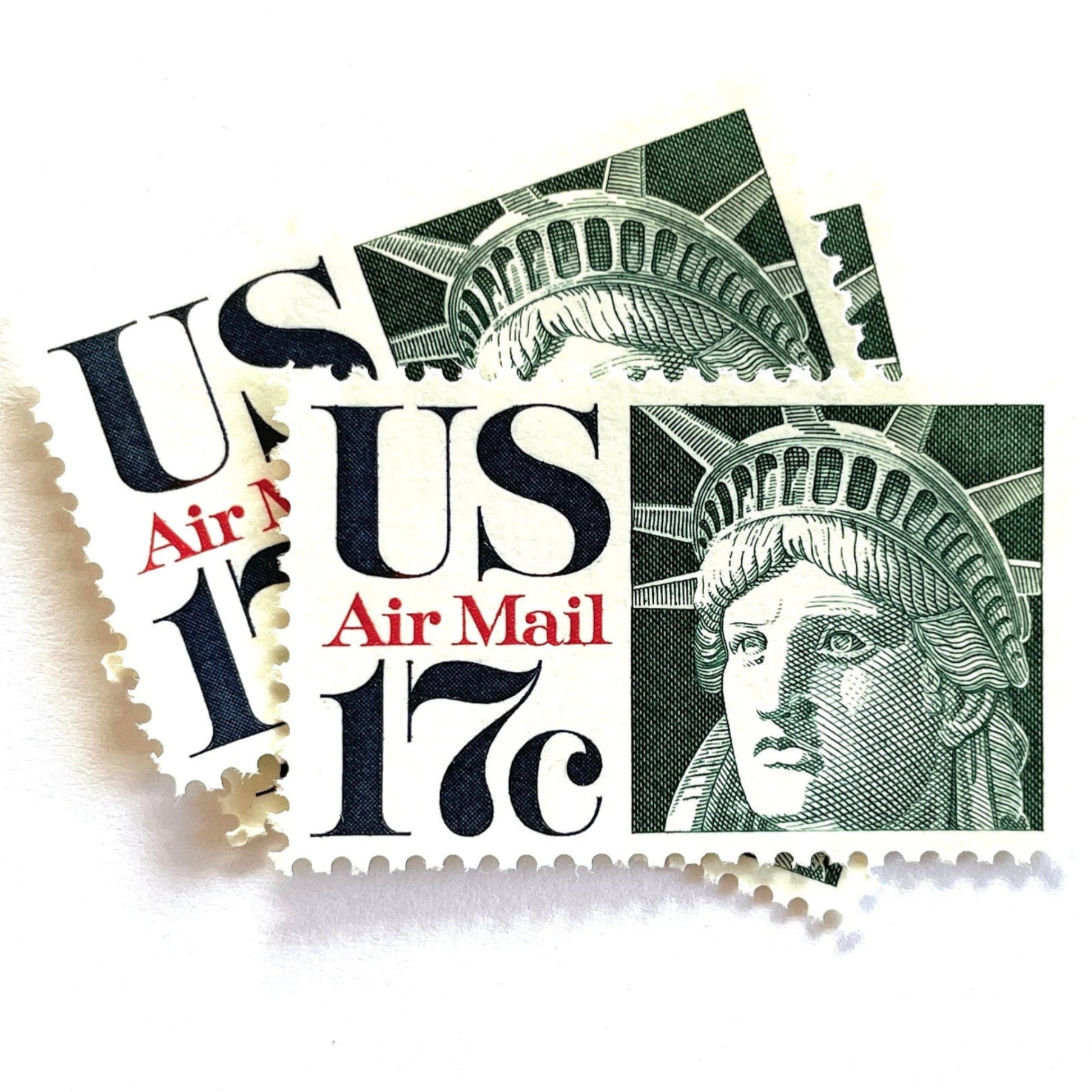 Image of 17-cent Airmail 1983 Liberty Crown USPS postage stamp featuring the Statue of Liberty. Scott #C80. Stamp themes: State of Liberty, Liberty Head, Lady Liberty, New York, NYC, Big Apple, Liberty Island, Immigrants, Immigration, Hope, Freedom, Refuge, Democracy, Crown, Torch, Tablet, Landmark, National Monument, United States of America. Green postage stamp.