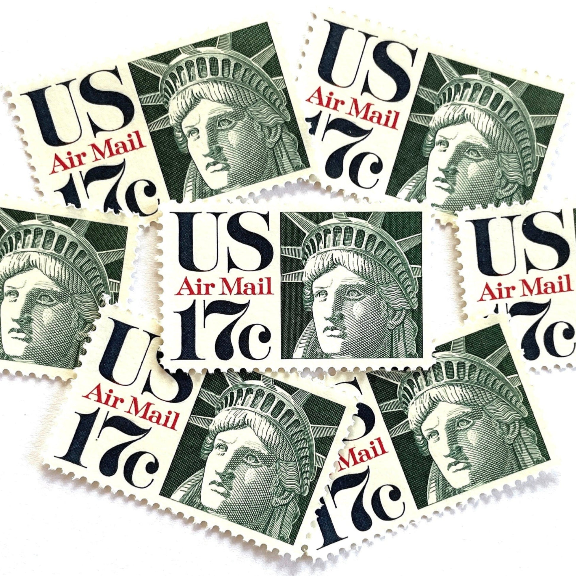 Image of 17-cent Airmail 1983 Liberty Crown USPS postage stamp featuring the Statue of Liberty. Scott #C80. Stamp themes: State of Liberty, Liberty Head, Lady Liberty, New York, NYC, Big Apple, Liberty Island, Immigrants, Immigration, Hope, Freedom, Refuge, Democracy, Crown, Torch, Tablet, Landmark, National Monument, United States of America. Green postage stamp.