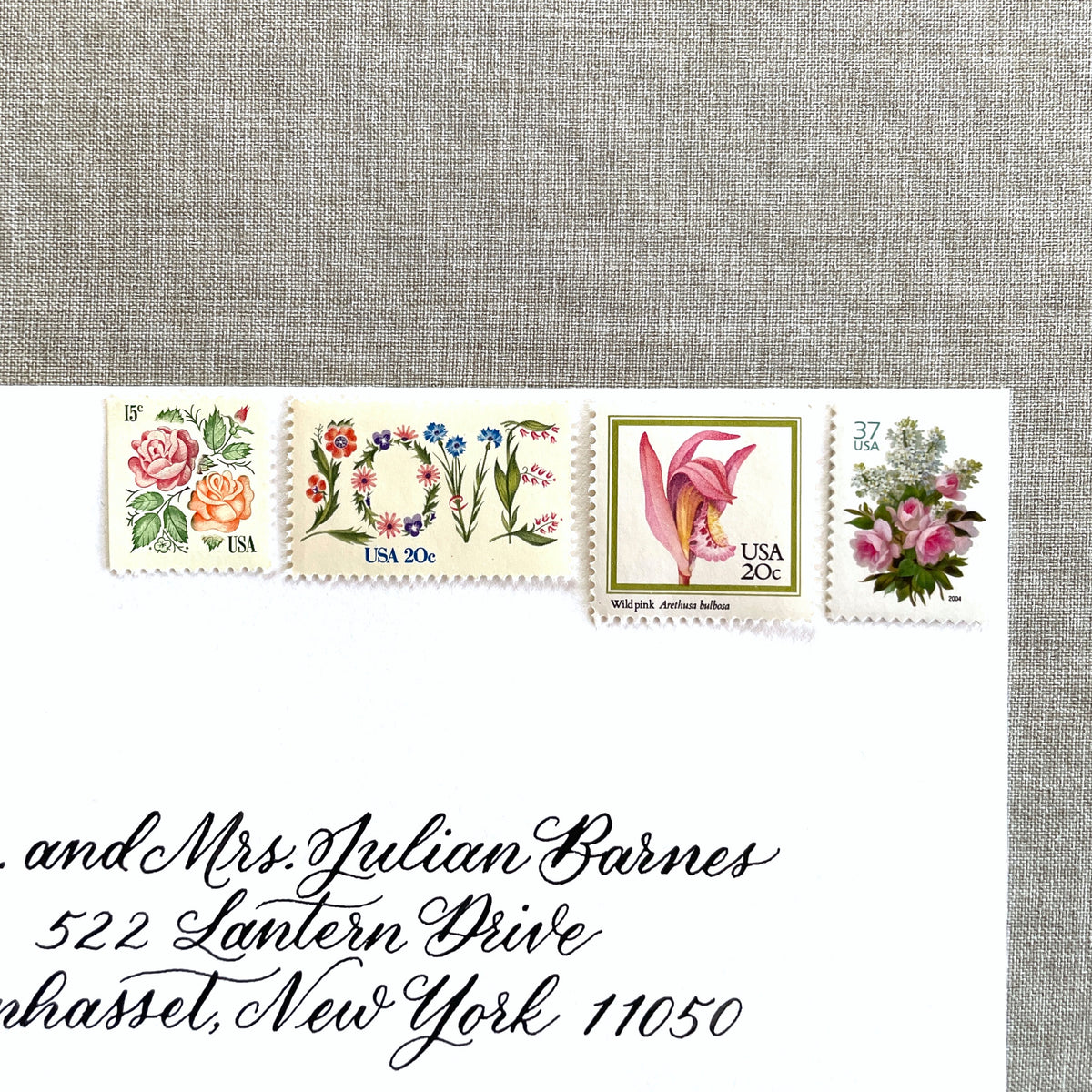 Image of four unused vintage stamps curated and arranged in a USPS postage stamp set for mailing floral and love-themed save-the-dates, wedding invitations, bridal shower invitations, and other special correspondence. This postage stamp set is called the “Pink Floral Love” set, is botanically themed, with pink as the predominant color. The total face value of the set is 92-cents USD.