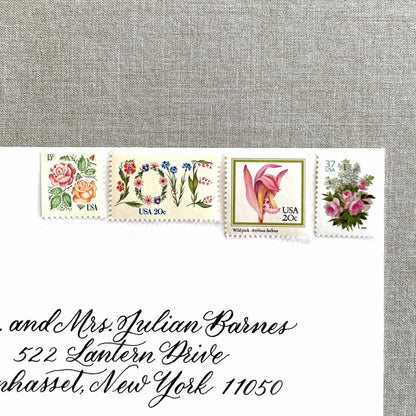 Image of four unused vintage stamps curated and arranged in a USPS postage stamp set for mailing floral and love-themed save-the-dates, wedding invitations, bridal shower invitations, and other special correspondence. This postage stamp set is called the “Pink Floral Love” set, is botanically themed, with pink as the predominant color. The total face value of the set is 92-cents USD.