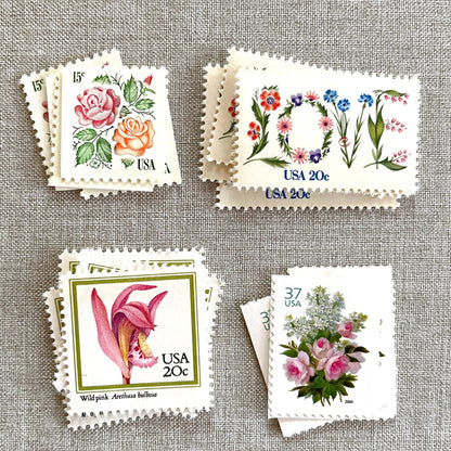 Image of four unused vintage stamps curated and arranged in a USPS postage stamp set for mailing floral and love-themed save-the-dates, wedding invitations, bridal shower invitations, and other special correspondence. This postage stamp set is called the “Pink Floral Love” set, is botanically themed, with pink as the predominant color. The total face value of the set is 92-cents USD.