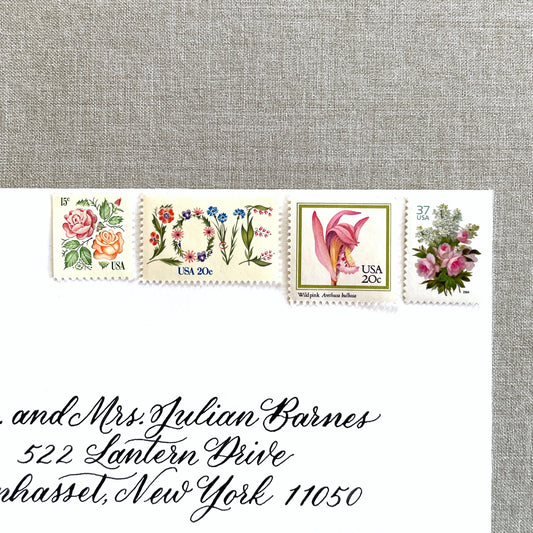 ALT TEXT:  Image of four unused vintage stamps curated and arranged in a USPS postage stamp set for mailing floral and love-themed save-the-dates, wedding invitations, bridal shower invitations, and other special correspondence. This postage stamp set is called the “Pink Floral Love” set, is botanically themed, with pink as the predominant color. The total face value of the set is 92-cents USD.