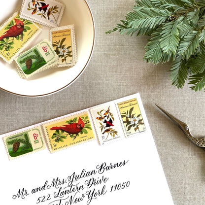 Unused “Gold Botanical Christmas” vintage postage stamp set perfect for adding a special touch to your holiday cards or letters! Each curated set is comprised of four (4) unused stamps with a total USPS postage value of $0.84 (USD) per set — enough postage to mail a standard letter weighing up to 1-ounce.