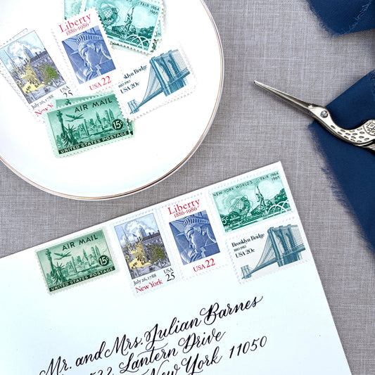 Unused vintage stamp set perfect for mailing New York or NYC-themed wedding invitations, save-the-dates, engagement announcements, bridal shower invites, thank you notes, or other special correspondence. Each curated set is comprised of five unused stamps with a total USPS postage value of 87 cents, enough postage to mail a standard letter weighing up to 1 ounce. These unused U.S. stamps are perfectly valid for use as postage.