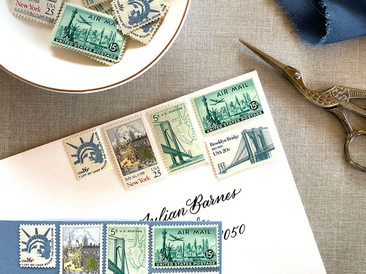These unused vintage stamp sets are perfect for mailing New York or NYC-themed wedding invitations, save-the-dates, engagement announcements, bridal shower invites, thank you notes, or other special correspondence. Each curated set is comprised of five (5) unused stamps with a total USPS postage value of 81 cents — enough postage to mail a standard letter weighing up to 1 ounce. These unused U.S. stamps are perfectly valid for use as postage.